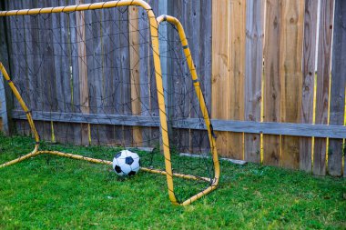 Backyard chldren soccer at the wood fence with wall clipart