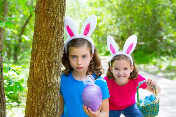 Easter girls playing on forest with bunny teeth gesture — Stock Photo, Image