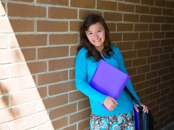 Schoolgirl teenager at school brick wall happy — Stock Photo, Image