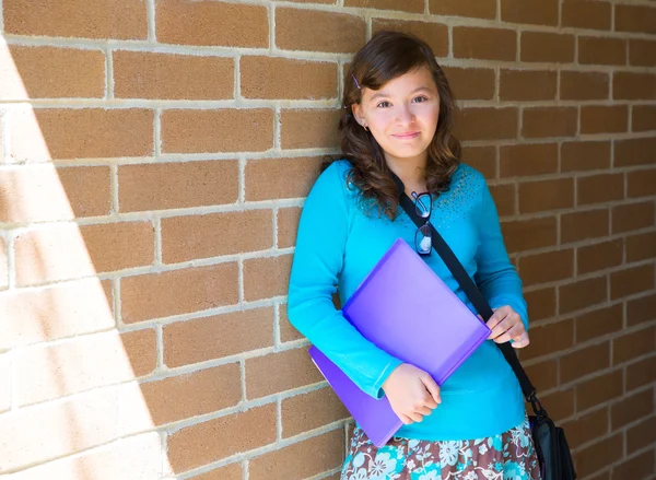 Schoolgirl teenager at school brick wall happy — Stock Photo, Image