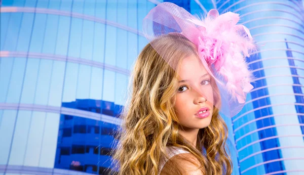 Blond fashion girl with pink hat in blue skyscrapers — Stock Photo, Image