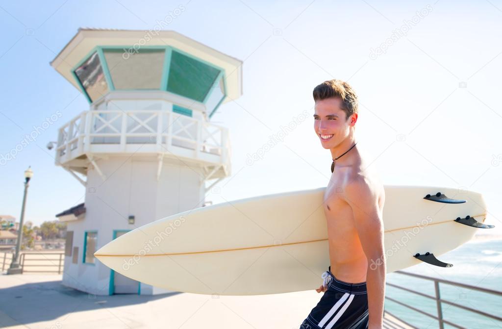 Surfer boy teen with surfboard in Huntington beach