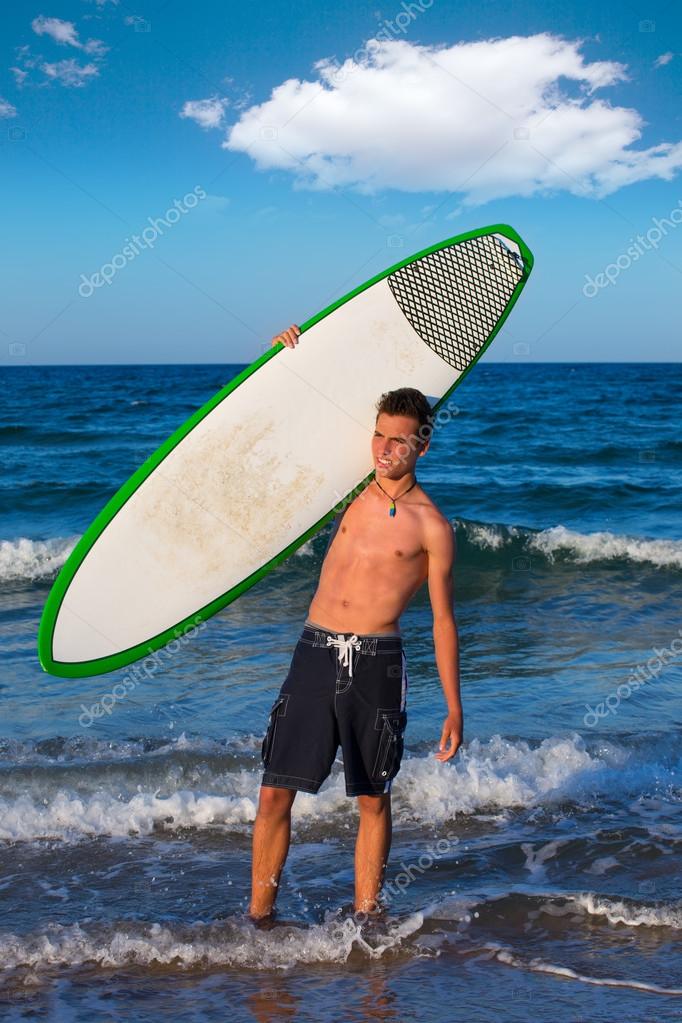 Boy teen surfer holding surfboard in the beach — Stock Photo ...