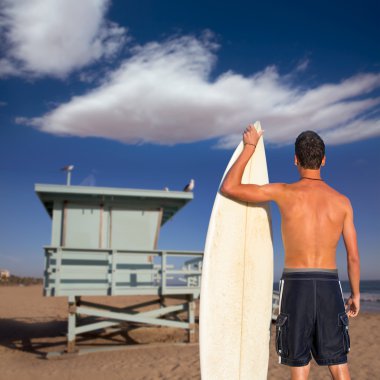 Çocuk sörfçü geri görüntülemek surfboard holding kumsalda