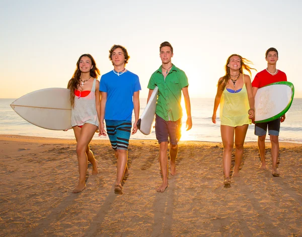 Αγόρια και κορίτσια ομάδα των surfers περπάτημα στην παραλία — Φωτογραφία Αρχείου