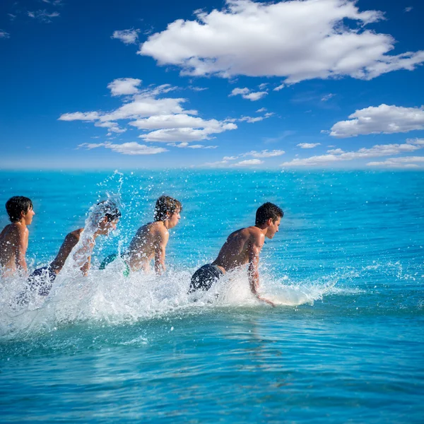 Boys surfers surfing running jumping on surfboards — Stock Photo, Image