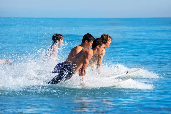 Boys surfers surfing running jumping on surfboards — Stock Photo, Image