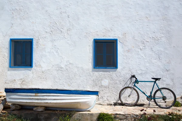 Mediterranean boat bicycle and white wall in white — Stock Photo, Image