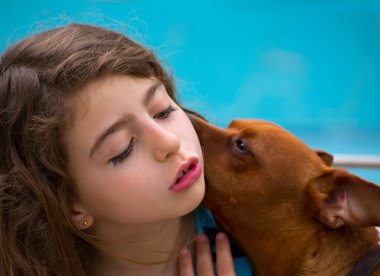 Brunette kid girl and dog pet whispering ear clipart