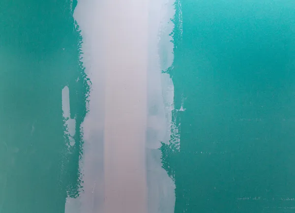 Υδρόφοβες γυψοσανίδα γυψοσανίδας σε πράσινο plaste ραφή — Φωτογραφία Αρχείου