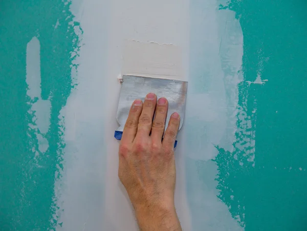 Drywall hydrophobic plasterboard trowel plastering seam — Stock Photo, Image