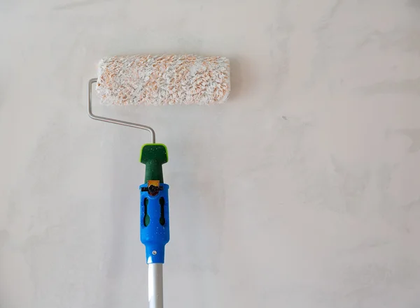 Paint roller for painting wall after plastering — Stock Photo, Image