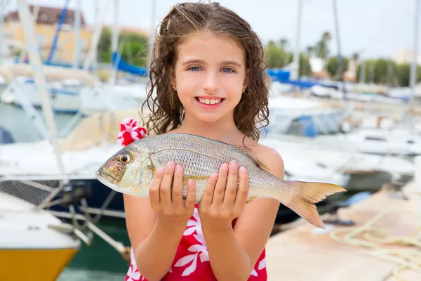 Happy kid fisherwoman with dentex fish catch — Stock Photo, Image