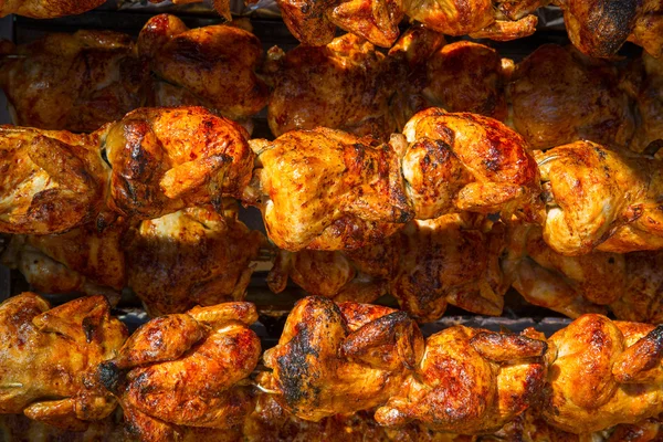 Roasted chicken in a row turning on a roaster — Stock Photo, Image