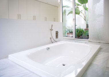 Modern white house bathroom bathtub with courtyard skylight clipart