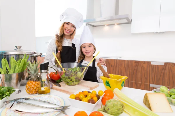 Kid girls junior chef friends hug together in countertop — Stock Photo, Image