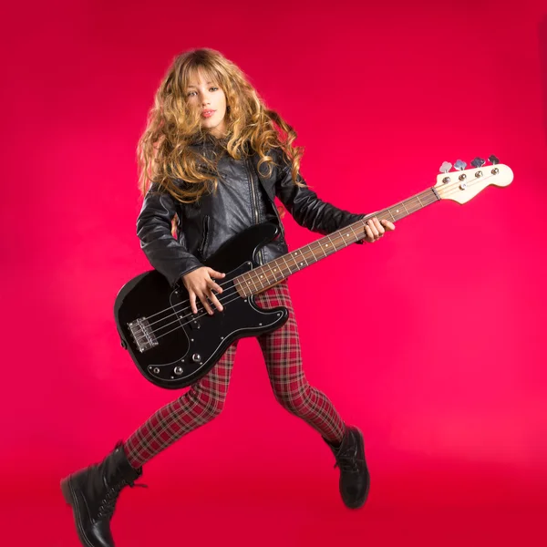 Blond Rock and roll girl with bass guitar jump on red — Stock Photo, Image