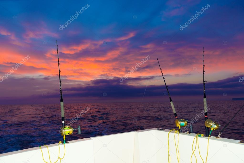 boat fishing trolling at sunset with rods and reels