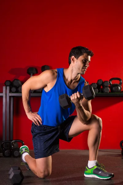 Hex dumbbells man workout in red gym — Stock Photo, Image