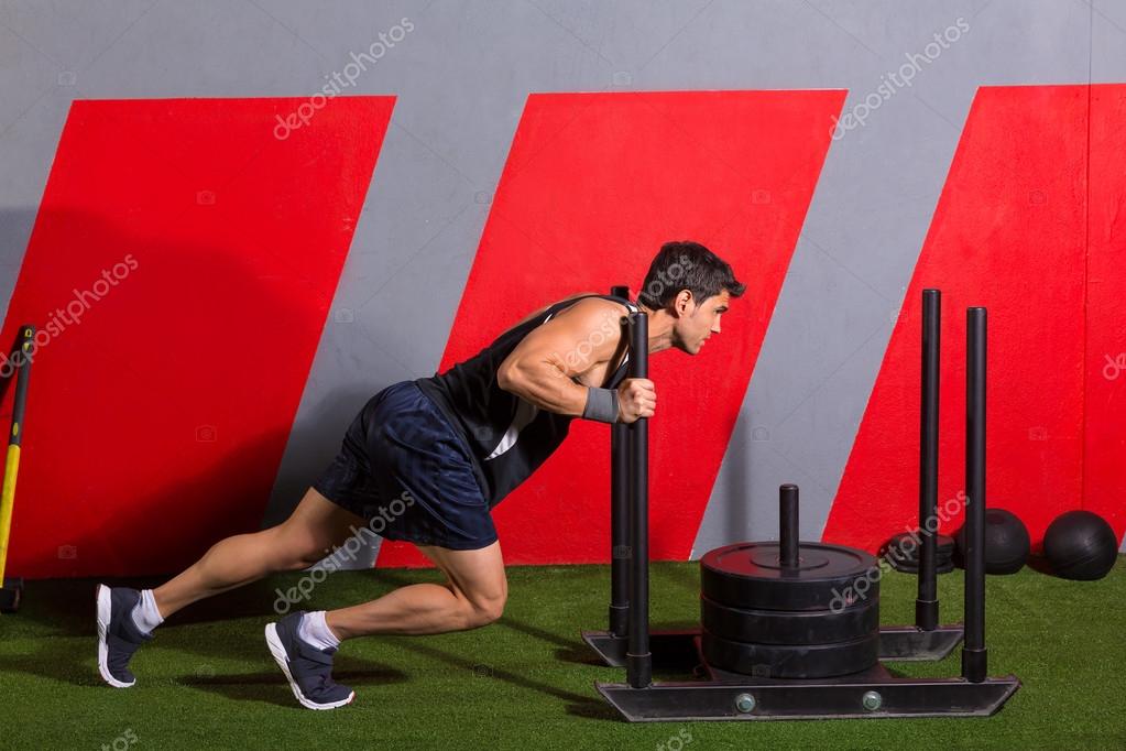 Sled push man pushing weights workout exercise Stock Photo lunamarina 44287887