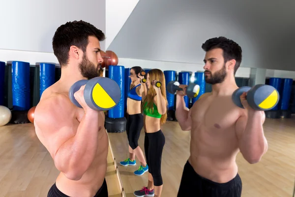 Dumbbell levantamiento de pesas hombre mujeres grupo en el espejo —  Fotos de Stock