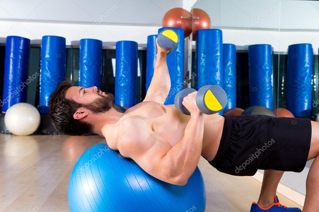Dumbbell chest press on fit ball man workout — Stock Photo © lunamarina