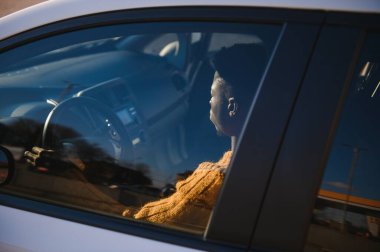 İçki içerken yüksek teknolojili elektrikli aracıyla yakışıklı bir Afro-Amerikalı. Otomatik sürüş aracı kavramı