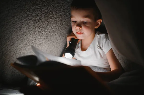 Menino Com Lanterna Livro Leitura Sob Cobertor Casa — Fotografia de Stock