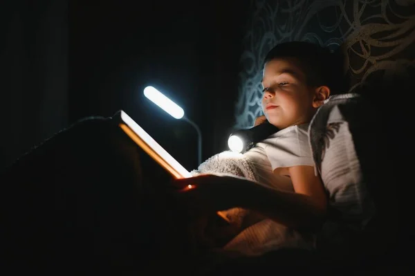Lectura Libro Uso Linterna Niño Con Ropa Casual Acostado Cerca — Foto de Stock