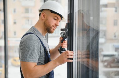 Süre installing pencere kapalı matkap kullanarak inşaat işçisi