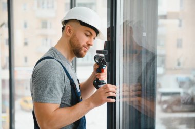 Süre installing pencere kapalı matkap kullanarak inşaat işçisi