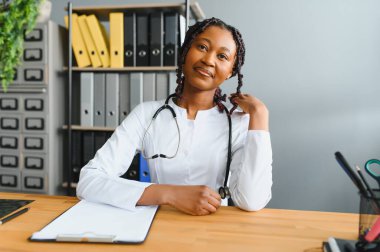 Afrikalı kadın doktor çevrimiçi teletıp görüntülü arama hastası yapıyor. Afro-Amerikalı siyahi kadın terapist uzaktan video konferans sohbetinde kamerayla konuşuyor. Web kamerası görüntüsü, yüz görüntüsü