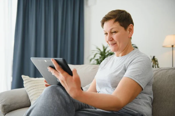 中年妇女举行数码平板电脑会议通过社交距离虚拟家庭在线聊天会 — 图库照片