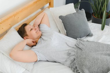 Orta yaşlı bir kadın evde yatakta uyuyor.