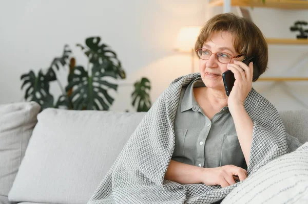 漂亮的祖母在家里讲电话 — 图库照片