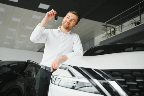 Happy customer just bought a car at car dealership.