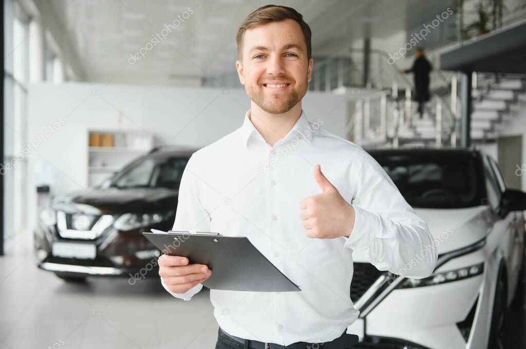 friendly vehicle salesman presenting new cars at showroom. Concept for car rental.