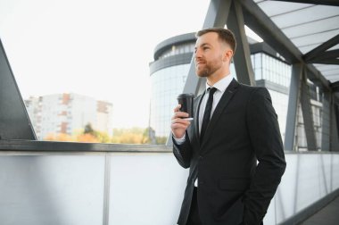 Modern bir iş ortamında gülümseyen bir iş adamının portresi..