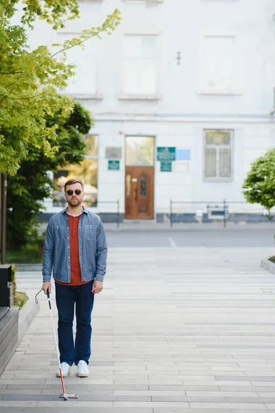 Close-up Of A Blind Man Standing With White Stick On Street.