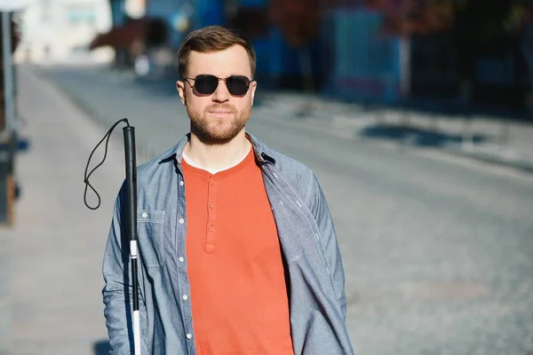 Close-up Of A Blind Man Standing With White Stick On Street.