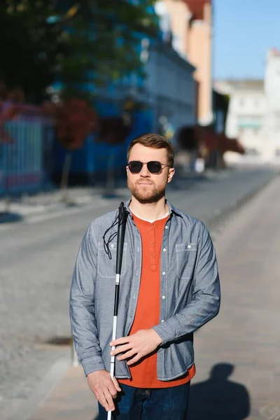 Close-up Of A Blind Man Standing With White Stick On Street.