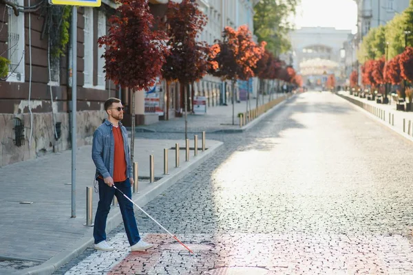 Blind man. People with disability, handicapped person and everyday life. Visually impaired man with walking stick