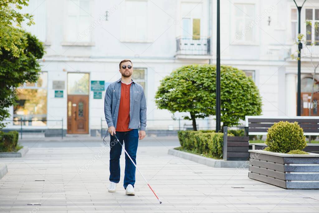 Blind man. People with disability, handicapped person and everyday life. Visually impaired man with walking stick