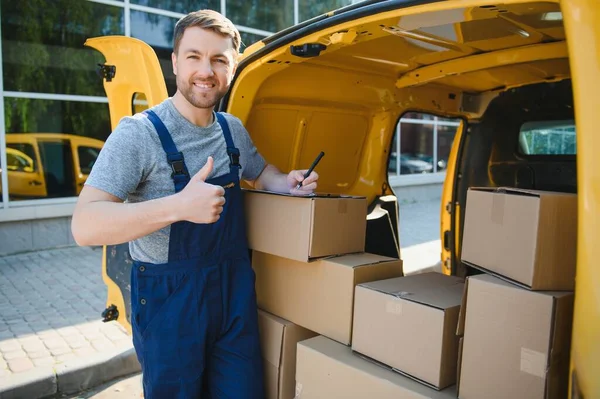 The courier brought the delivery of the box to the client. Courier service employee in uniform