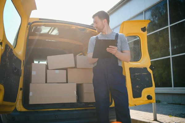 The courier brought the delivery of the box to the client. Courier service employee in uniform