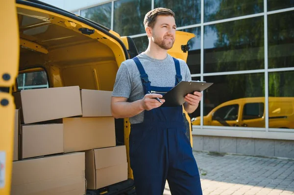 Courier service for the delivery of goods. Express service a man in a uniform delivers boxes. The employee carries the order home to the client