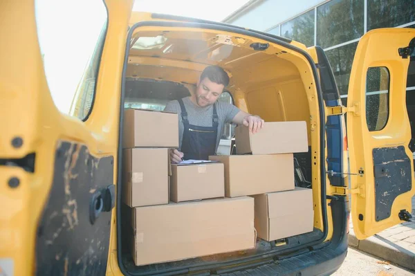 The courier brought the delivery of the box to the client. Courier service employee in uniform