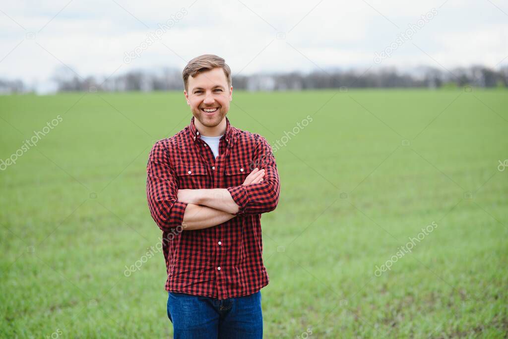 Portrait of farmer standing in wheat field