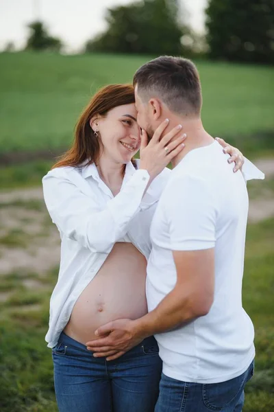 Ευτυχισμένο Και Νεαρό Έγκυο Ζευγάρι Αγκαλιάζει Στη Φύση — Φωτογραφία Αρχείου