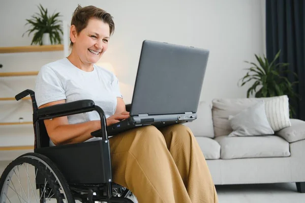 Frau Mittleren Alters Sitzt Mit Laptop Rollstuhl Hause — Stockfoto